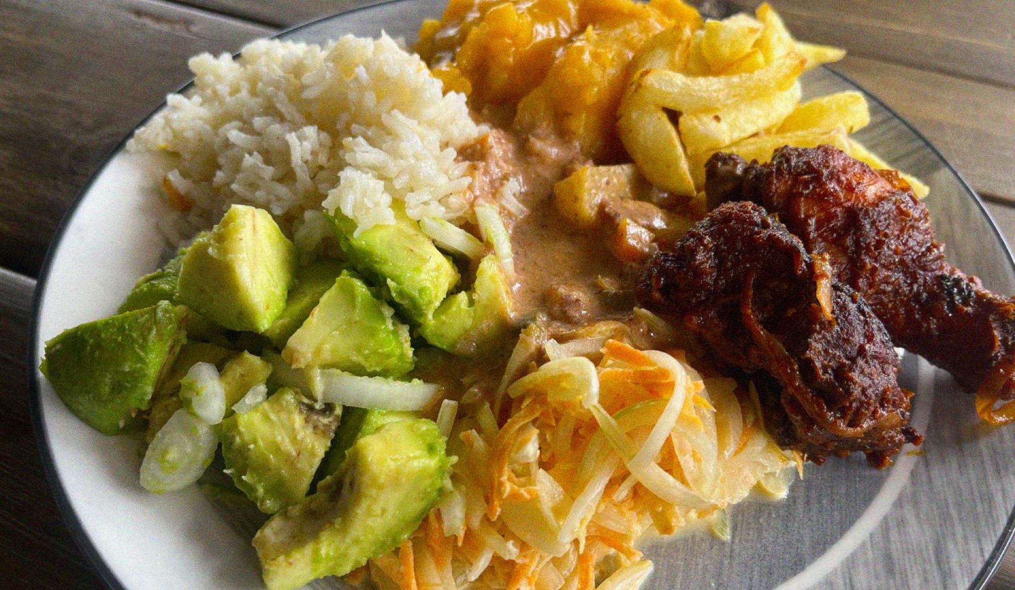 Buffets are a popular lunch option - this plate of avocado, stewed matoke, peanut sauce and grilled chicken wings comes in at £2.20(!)