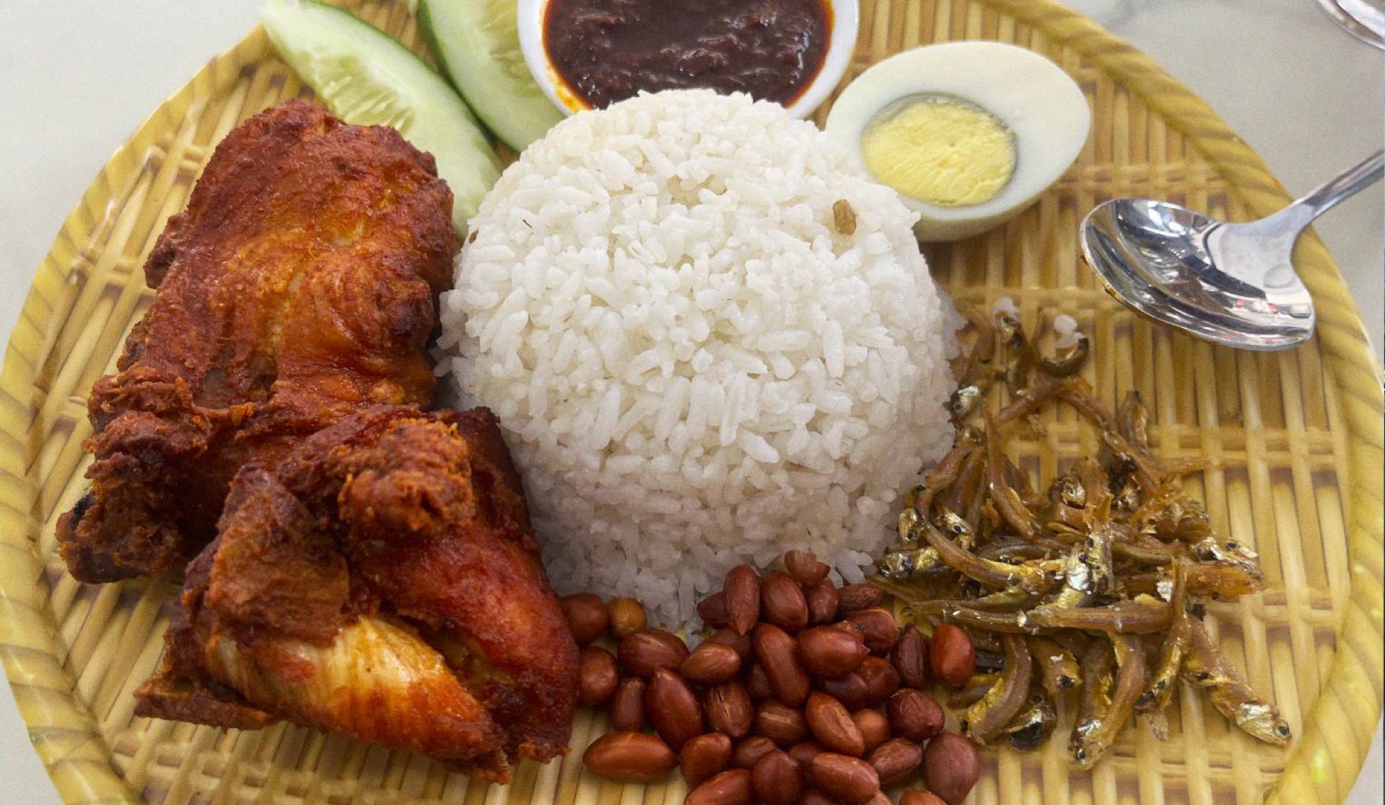 Nasi Lemak is the national dish of Malaysia. Fragrant rice cooked in coconut milk is served with an egg, sambal (a chili sauce), anchovies, and peanuts. It's often served with a protein like fried chicken (Ayam Goreng) or Rendang. A perfect breakfast or lunch option.